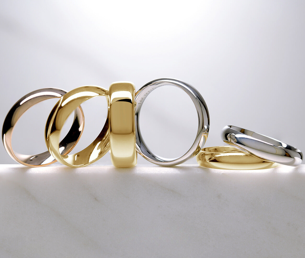 classic white and yellow domed gold wedding bands in assorted widths