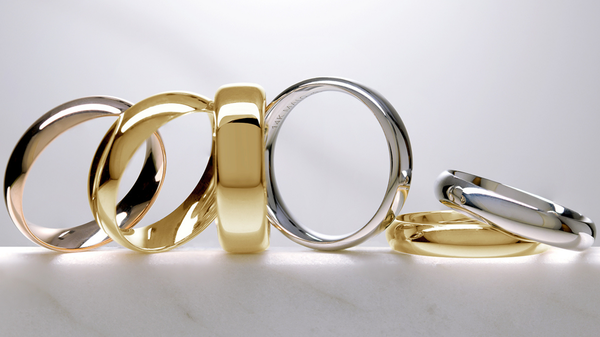 classic white and yellow domed gold wedding bands in assorted widths